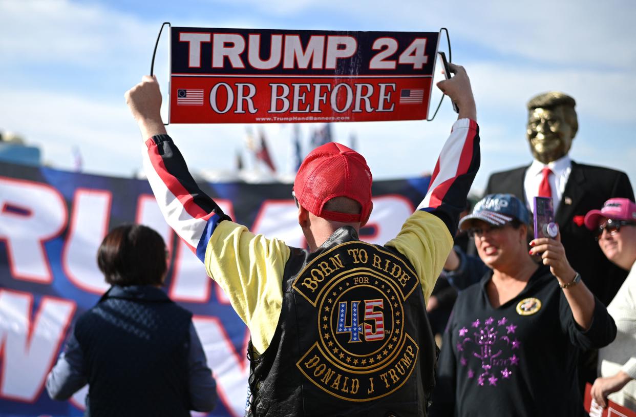 Trump supporter Jonathan Riches holds a sign that reads: Trump 24 or before.