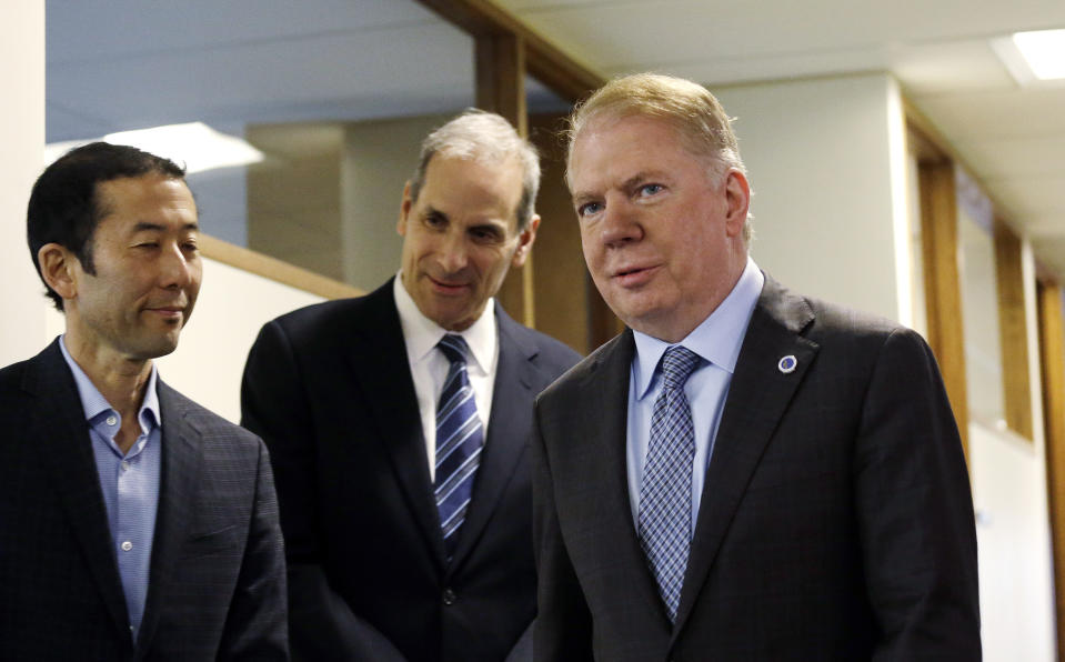 Seattle Mayor Ed Murray, right, walks past his husband, Michael Shiosaki, left, and his attorney, Bob Sulkin, before speaking to the media, Friday, April 7, 2017, in Seattle. Three men claim that Murray sexually abused them in the 1980s, paying for sex when they were teenagers and Murray was in his 30s. Murray denied the allegations and said he will not step down. (AP Photo/Elaine Thompson)