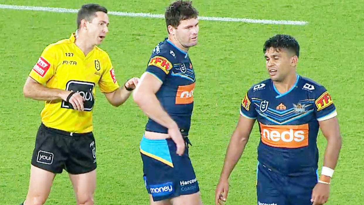 Titans star Tyrone Peachey (pictured right) walking away after telling the ref he was allegedly the target of a racial slur.