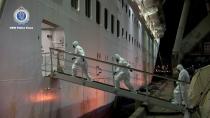 NSW Police personnel in personal protective equipment board the Ruby Princess during the Strike Force Bast raid of the cruise ship at Port Kembla