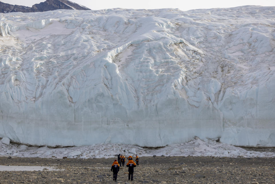New Zealand Prime Minister Jacinda Ardern and her partner, Clarke Gayford, walk toward the front of a glacier in the Taylor Valley, one of Antarctica's iconic dry valleys, Thursday, Oct. 27, 2022. (Mike Scott/NZ Herald via AP, Pool)