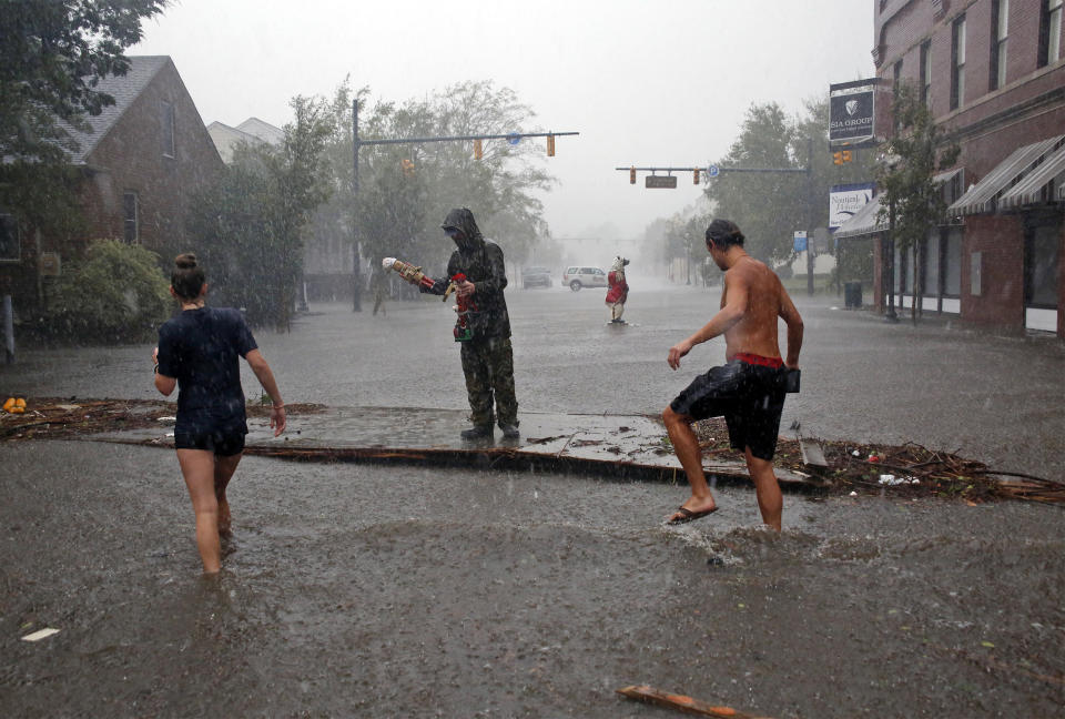 People survey the damage caused by Hurricane Florence on Front Street in downtown New Bern, North Carolina on Friday.
