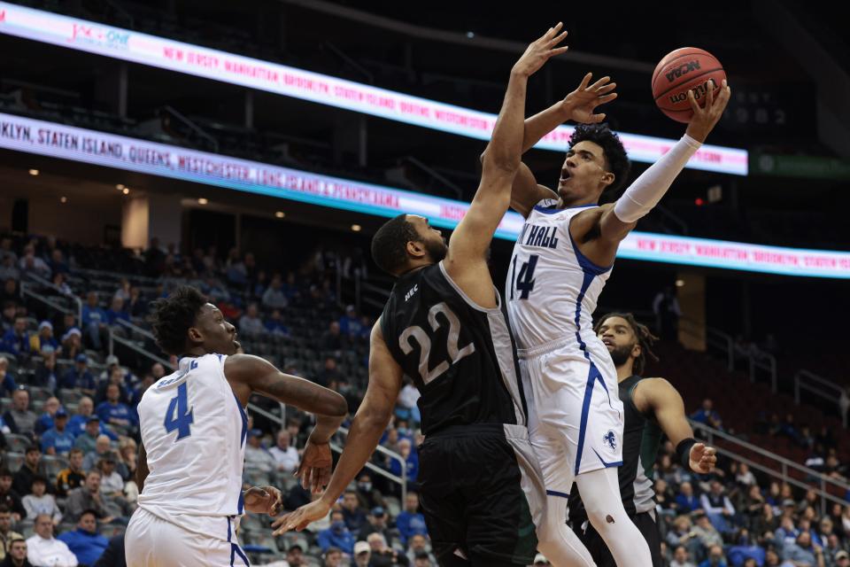 Seton Hall Pirates guard Jared Rhoden (14) shoots the ball against Wagner Seahawks forward Ja'Mier Fletcher (22)