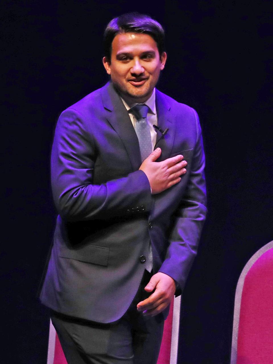 Akron Mayor Shammas Malik acknowledges the applause from the audience as he takes the stage for a ceremonial swearing-in as mayor at a public ceremony at EJ Thomas Hall in Akron on Saturday.