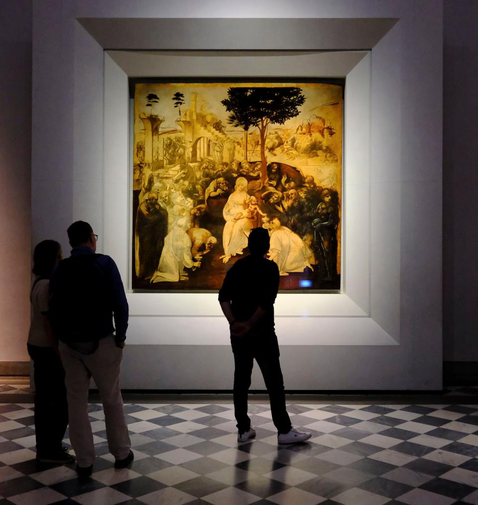 May 11 2024; Florence, Italy; Patrons at Ufizzi Gallery study an unfinished painting by Leonardo da Vinci depicting Mary with the baby Jesus. The painting was commissioned as an altar piece by a church in Florence.