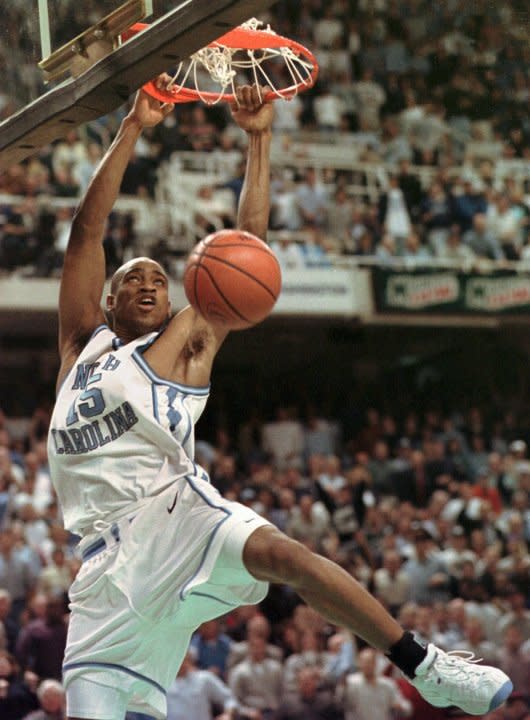 North Carolina forward Vince Carter completes a 360-degree dunk during the Tar Heels NCAA East Regional final against the University of Connecticut Huskies Saturday, March 21, 1998, at the Greensboro Coliseum in Greensboro, N.C. North Carolina won the game 75-64. (AP Photo/Bob Jordan)