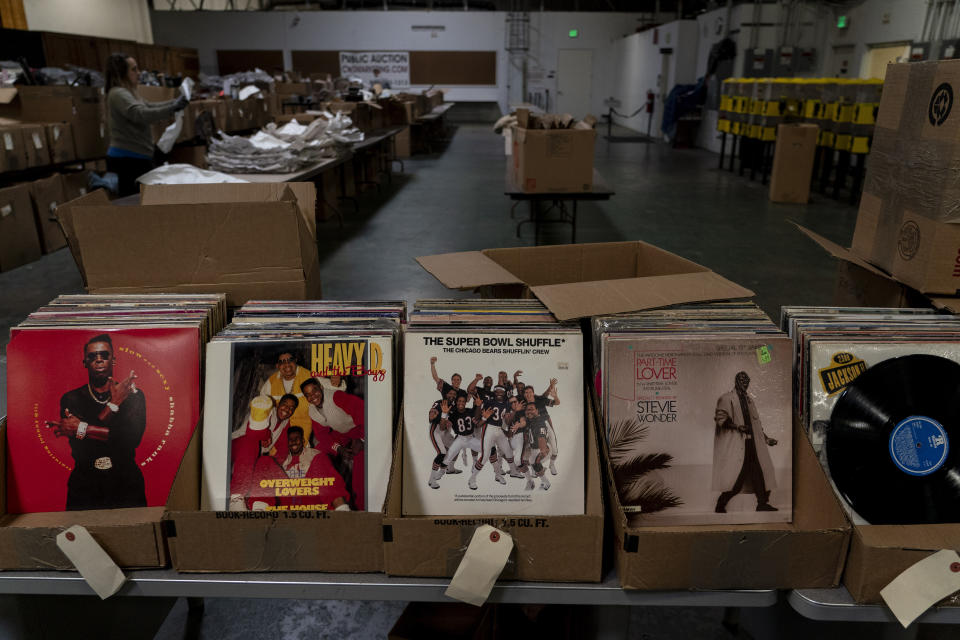 Vinyl records are on display to be auctioned off at a Los Angeles County warehouse in the County of Los Angeles, Calif., Thursday, June 15, 2023. The warehouse is filled with belongings from people's estates, including anything from doll collections and clothes to framed paintings, china dishware, washing machines, and cars, much of it housed in massive wooden crates. The items will be auctioned off to the public to pay off the estates' debts and cover burial or cremation services. (AP Photo/Jae C. Hong)