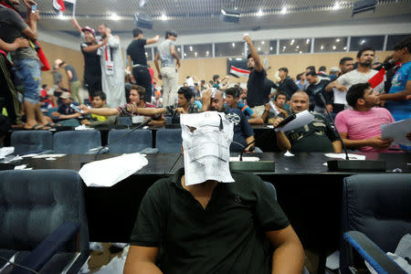 Followers of Iraq's Shi'ite cleric Moqtada al-Sadr are seen in the parliament building as they storm Baghdad's Green Zone after lawmakers failed to convene for a vote on overhauling the government, in Iraq April 30, 2016. REUTERS/Ahmed Saad