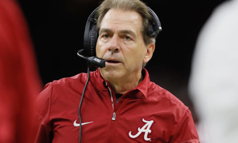 A closeup of Nick Saban wearing a headset during an Alabama football game.