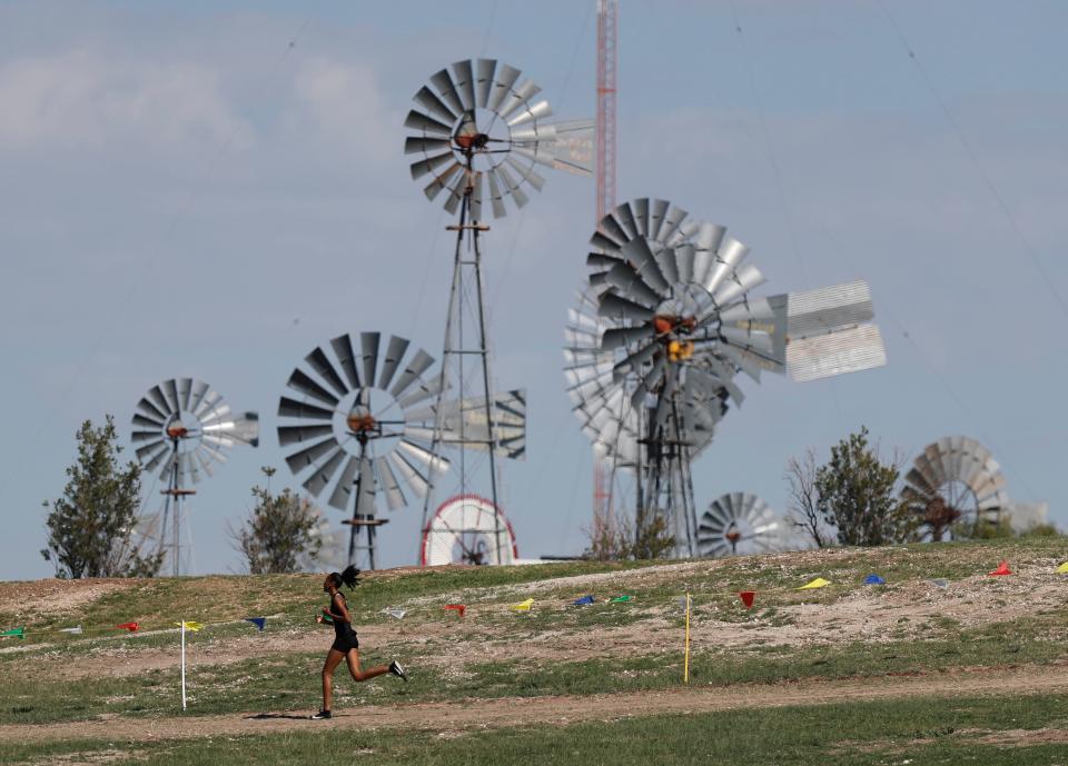 A runner passes the American Windmill Museum in Lubbock. It's one of the must-see stops on any roadtrip to the High Plains city.