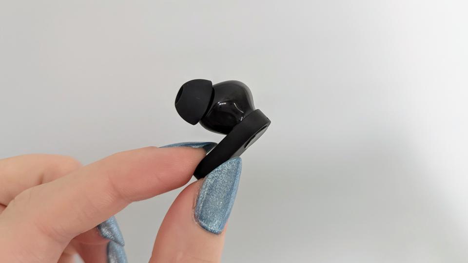 OnePlus Nord Buds review: earbud held up against a wall