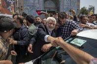 Candidate for the Iran's presidential election Saeed Jalili, a hard-line former nuclear negotiator, shakes hand with a supporter after casting his vote for the presidential runoff election in Qarchak near Tehran, Iran, Friday, July 5, 2024. Iran was holding a runoff presidential election Friday pitting a hard-line former nuclear negotiator against a reformist lawmaker, though both men earlier struggled to convince a skeptical public to cast ballots in the first round that saw the lowest turnout in the Islamic Republic's history. (AP Photo)