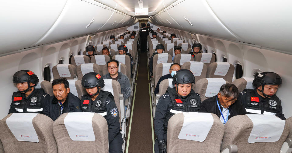 Criminal suspects, including Bai Suocheng and Liu Zhengxiang, are escorted by Chinese police on a charter flight to China, Jan. 30, 2024, after Myanmar police handed over key leaders of Kokang fraud gangs and other alleged major criminals to China.<span class="copyright">Xinhua/Shutterstock</span>