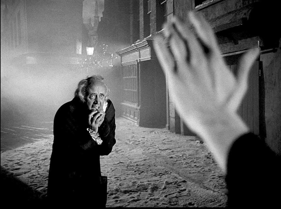 Ebenezer Scrooge (Alastair Sim) faces the Ghost of Christmas Yet to Come in the 1951 production of "A Christmas Carol."
