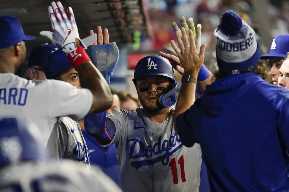 Los Angeles Dodgers' Miguel Rojas (11) celebrates after scoring off of a single hit by Michael Busch during the seventh inning of a baseball game against the Los Angeles Angels in Anaheim, Calif., Tuesday, June 20, 2023. (AP Photo/Ashley Landis)