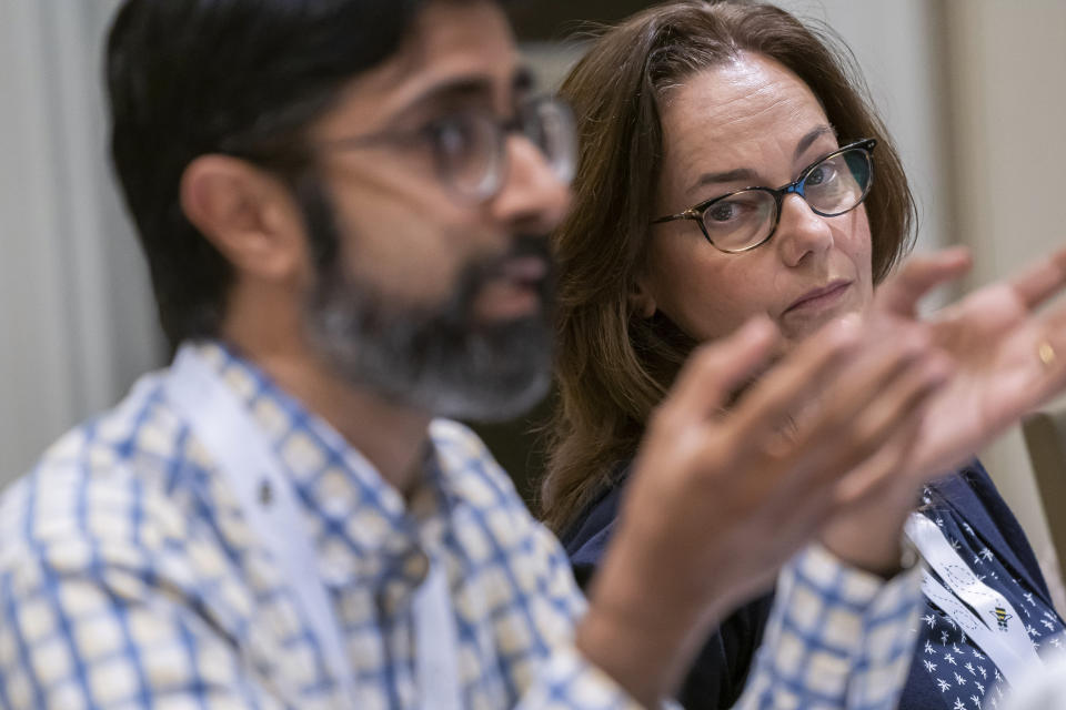 Georgia Scurletis, right, listens as Akshay Ahuja speaks during a pre-bee word panel meeting to finalize the 2023 Scripps National Spelling Bee words on Sunday, May 28, 2023, at National Harbor in Oxon Hill, Md. (AP Photo/Nathan Howard)