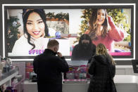 Cashier Druhan Parker, center, works behind a plexiglass shield Thursday, Nov. 19, 2020, as he checks out shoppers at an Ulta beauty store on Chicago's Magnificent Mile. The pandemic has forced people to spend more time with themselves than ever. Along the way, it has reshaped and broadened the way many think about and prioritize how they treat themselves — what has come to be called self-care. (AP Photo/Charles Rex Arbogast)