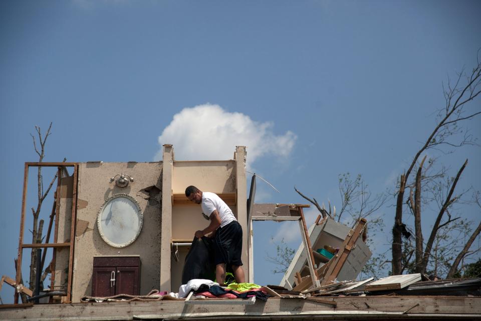 A man gathers his belongings from his damage home in Trotwood, Ohio, on May 28, 2019, after powerful tornadoes ripped through the US state overnight. (Photo: by Seth HeraldAFP/Getty Images)