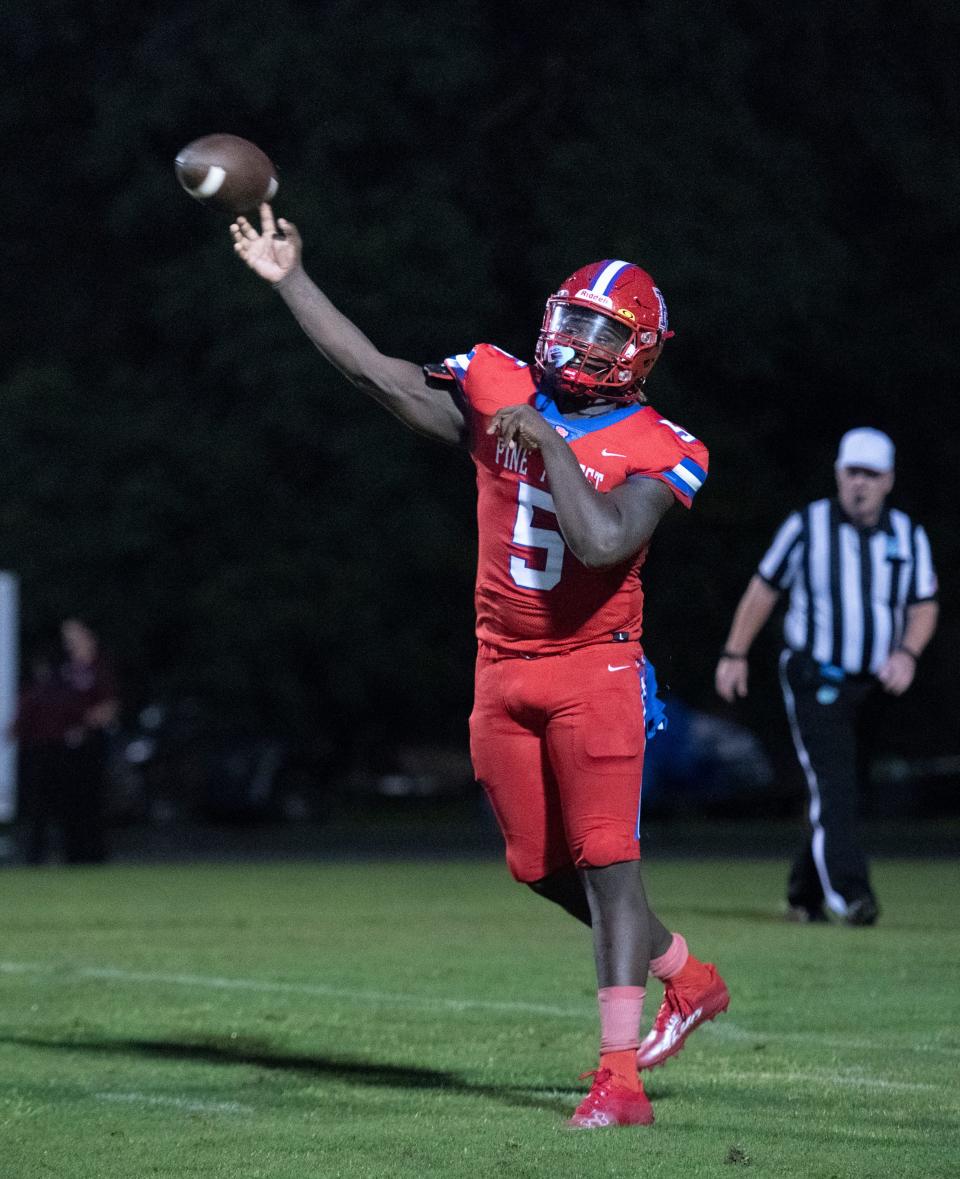 Quarterback T.J. Wilson (5) passes for a big pickup during the Tate vs Pine Forest football game at Pine Forest High School in Pensacola on Thursday, Aug. 25, 2022.