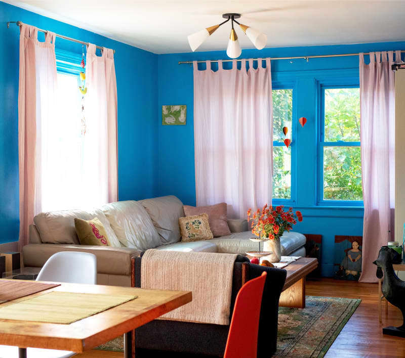 A leather couch behind a coffee table with decorative items a top.