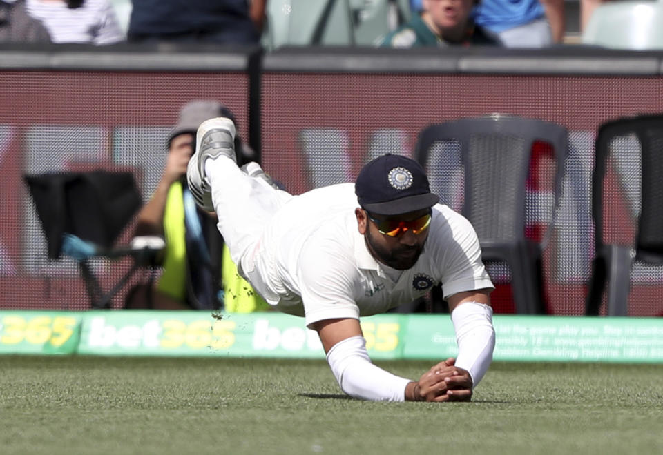 India's Ravi Ashwin takes a catch to dismiss Australia's Usman Khawaja during the first cricket test between Australia and India in Adelaide, Australia,Sunday, Dec. 9, 2018. (AP Photo/James Elsby)