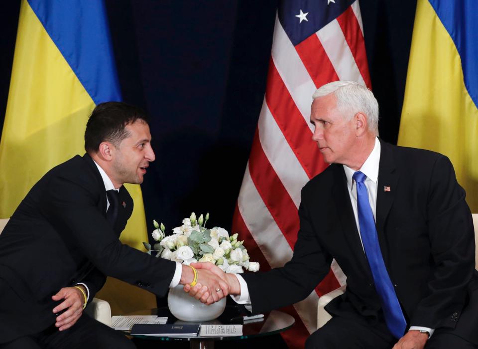 Ukraine's President Volodymyr Zelensky, left, shakes hands with U.S. Vice President Mike Pence, in Warsaw, Poland on Sept. 1, 2019.  A Washinton Post article published on Oct. 2, 2019 reported President Donald Trump used Pence in his attempt to pressure the new Ukrainian president to dig up dirt on Joe Biden, but is not conclusive on how much Pence knew about Trump's efforts.