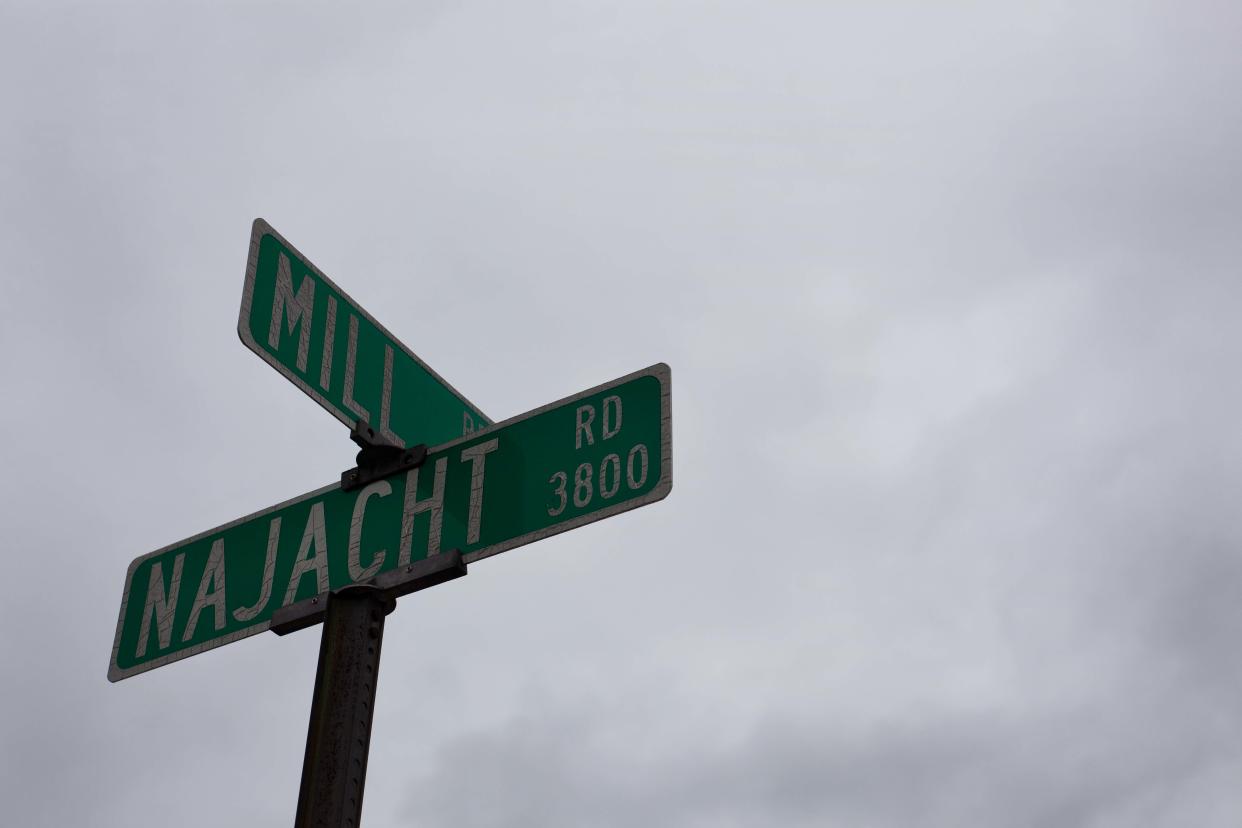 A sign indicates the intersection of Mill and Najacht roads on April 30.