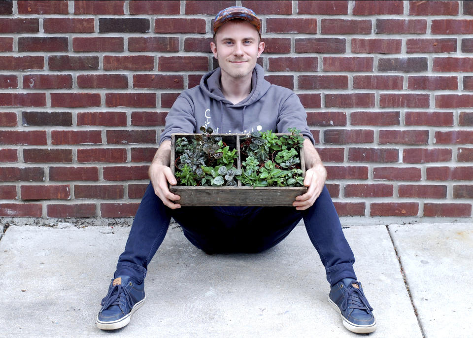 In this undated photo, plant influencer Nick Pileggi holds a variety of Peperomia outside the houseplant shop Urban Jungle in Philadelphia. Peperomias are popular houseplants on Instagram. (Sue Eggen via AP)