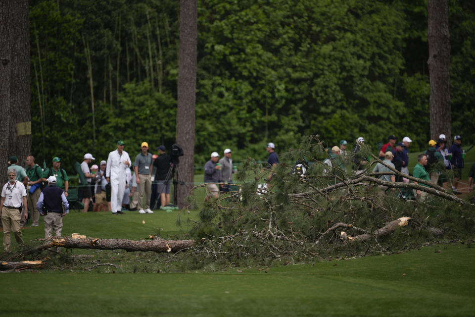 Authorities investigate the scene where trees fell on the 17th hole during the second round of the Masters golf tournament at Augusta National Golf Club on Friday, April 7, 2023, in Augusta, Ga. (AP Photo/Matt Slocum)