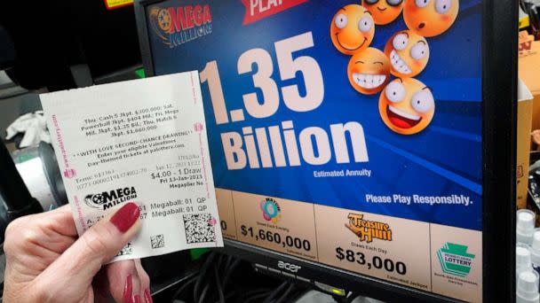 PHOTO: A customer at the Cranberry Super Mini Mart shows her Mega Millions ticket, Jan. 12, 2023, in Cranberry, Pa. (Gene J. Puskar/AP)