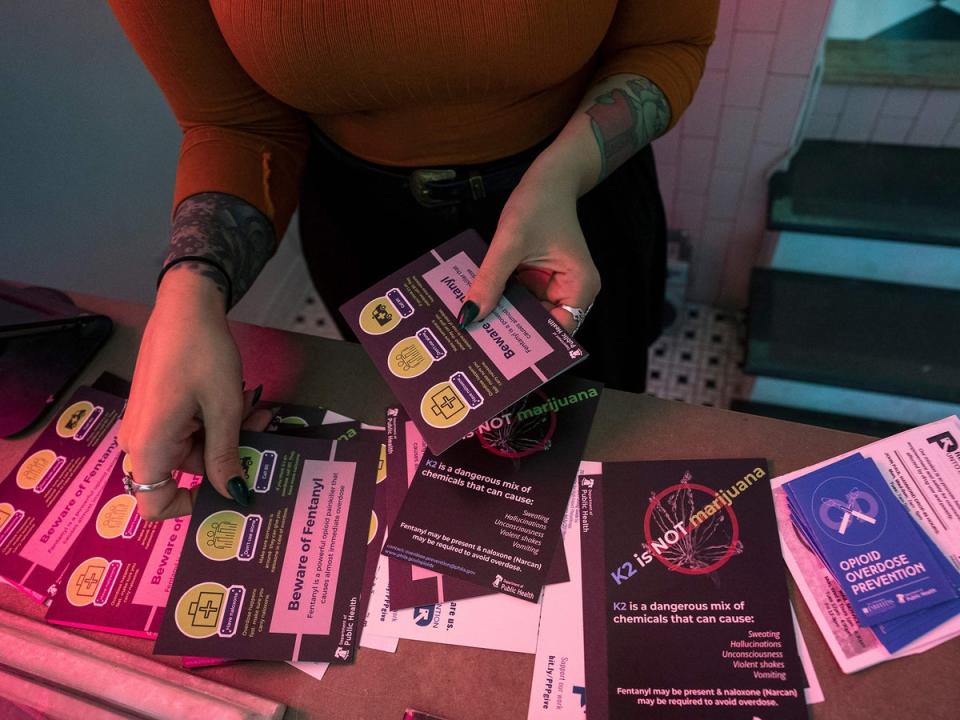 A volunteer in Philadelphia, Pennsylvania, sorts through information packets on how to help someone who has overdosed on opioids (Don Emmert/Getty Images)