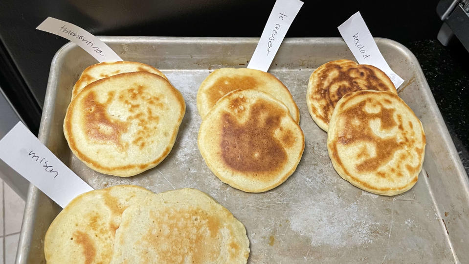 Pancakes with paper labels on a half sheet pan