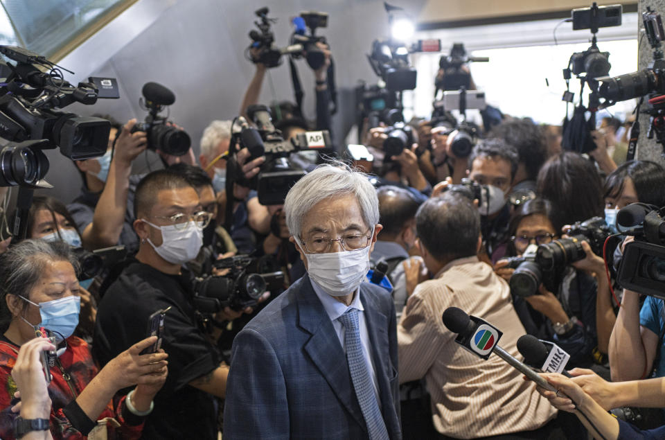 Pro-democracy activist Martin Lee, center, walks out from a court after receiving a suspended sentence in Hong Kong, Friday, April 16, 2021. A Hong Kong court on Friday sentenced five leading pro-democracy advocates, including media tycoon Jimmy Lai, to up to 18 months in prison for organizing a march during the 2019 anti-government protests that triggered an overwhelming crackdown from Beijing. A total of nine advocates were given jail terms, but four of them, including 82-year-old Lee, had their sentences suspended after their age and accomplishments were taken into consideration. (AP Photo/Vincent Yu)