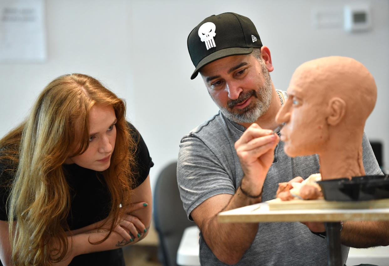 Joe Mullins works with third-year illustration major, Natalie Bennett, on her sculpture during the Forensic Skull Sculpture Workshop at Ringling College of Art and Design. Bennet only knows that her subject was a Caucasian male, age 45-60, whose body was found in Brooklyn, New York, in 2000.