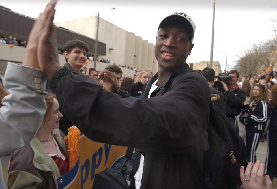 Marquette's Dwyane Wade greets fans that came out March 25, 2003, to give the team a sendoff as it left the old Marquette gym, heading for the second weekend of the NCAA tournament in Minneapolis.