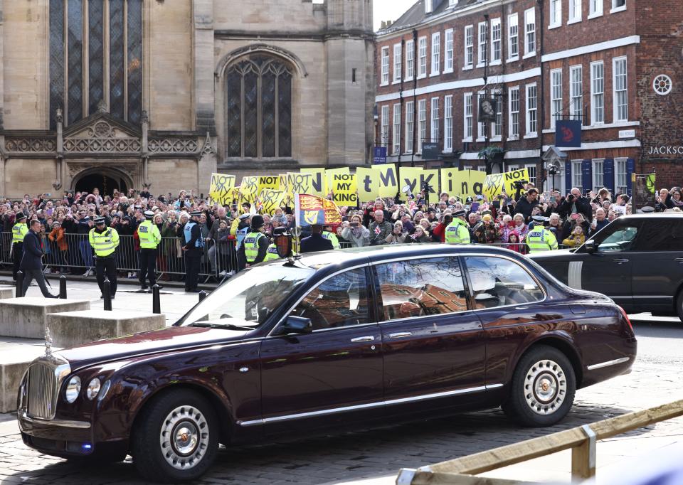 Protesters hold up banners and placards saying 'Not My King' during the arrival of the car bringing Britain's King Charles III and Britain's Camilla, Queen Consort to York Minster, for the distribution of the Maundy money to 74 men and 74 women, mirroring the age of the monarch, in York, northern England on April 6, 2023, to thank them for their outstanding Christian service and for making a difference to the lives of people in their local communities. - Maundy Thursday is the Christian holy day falling on the Thursday before Easter. The King commemorates Maundy by offering 'alms' to senior citizens. Each recipient receives two purses, one red and one white. (Photo by Darren Staples / AFP) (Photo by DARREN STAPLES/AFP via Getty Images)