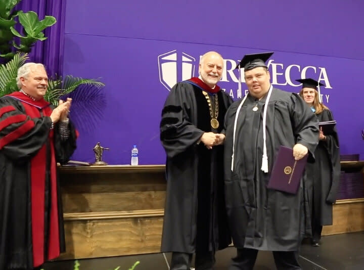 Brian Schnelle receives his college diploma from Trevecca Nazarene University President Dan Boone. (Credit: Trevecca Nazarene University)