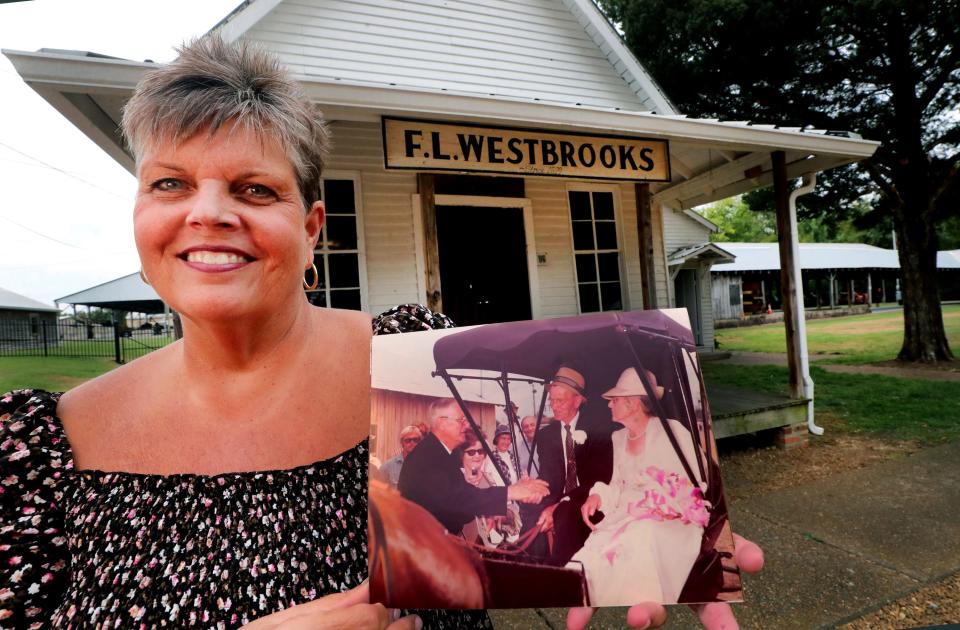 Barbara Hutson Fly holds a photo of her grandparents Arthur Straw Hudson and Vergie Douglas Hutson, on Tuesday, Sept. 12, 2023, as they were renewing their marriage vows in 1976 at Cannonsburgh Village at the Westbrooks store building that was relocated from Link community where the couple was married on the steps of the store in about 1913. Mayor Hollis Westbrooks, the grandson of the orginal store owner married the couple.