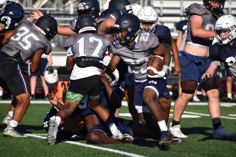 Decatur Central's Jordan Cox shifts through a pile of blockers and Castle defenders during the Hawks' four-way scrimmage with the Knights, Bloomington North and Speedway on June 23, 2022.