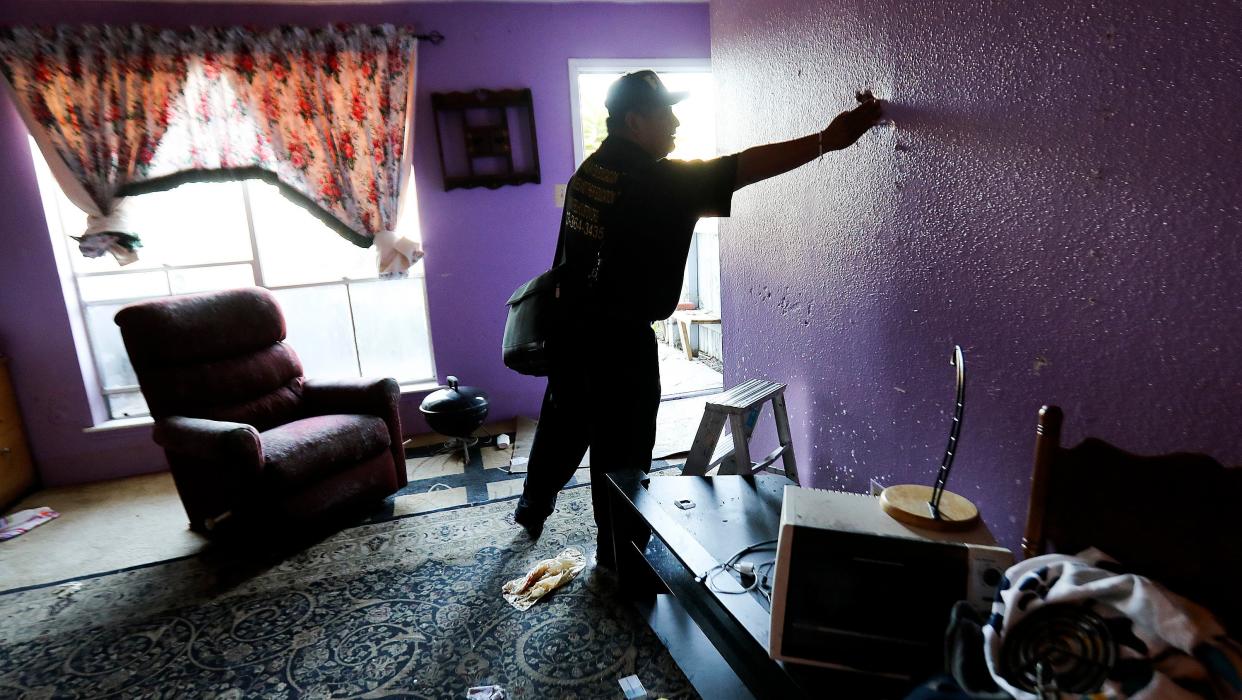 Community organizer Alain Cisneros easily puts his hand through a soaked wall in a Rockport Apartment that was damaged by Tropical Storm Harvey on Thursday, Sept. 7, 2017, in Houston. (Photo: Elizabeth Conley/Houston Chronicle)