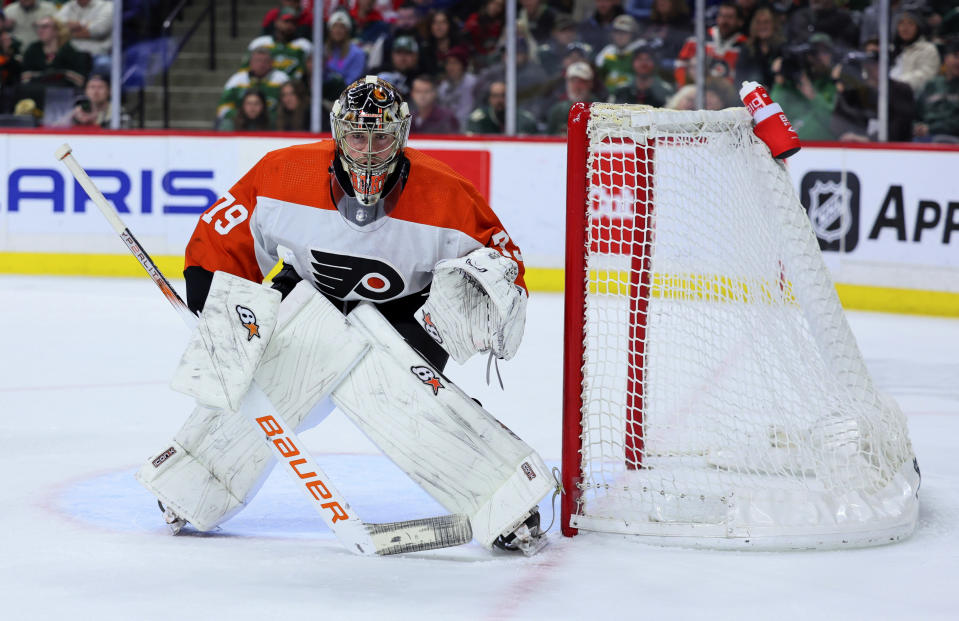 Philadelphia Flyers goaltender Carter Hart watches the puck during the third period of the team's NHL hockey game against the Minnesota Wild on Friday, Jan. 12, 2024, in St. Paul, Minn. (AP Photo/Adam Bettcher)