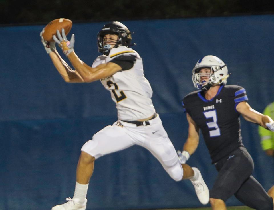 Fort Meade's Josh Porter catches a 25-yard touchdown pass in front of Parker Galberaith on the first play of the second quarter on Thursday night at Viking Stadium.