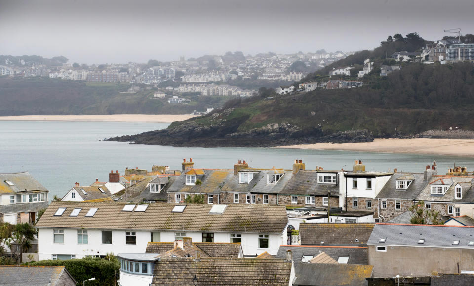 ST IVES, ENGLAND - OCTOBER 10:  Properties in the town of St Ives, which has introduced measures to limit the number of second homes, are seen in St Ives on October 10, 2017 in Cornwall, England. Following on from St Ives the picturesque Cornish coastal fishing village of Mevagissey has also submitted plans to Cornwall Council to block outsiders buying new-builds to use as holiday homes in an attempt to give local first-time buyers better chances of getting on the property ladder rather than being outbid by wealthy second home owners. The village's Neighbourhood Development Plan has highlighted that currently twenty six per cent of the homes in Mevagissey are holiday homes with average prices, according to Rightmove, of £299,587, nearly £50,000 more than the Cornish average of £250,000, and 20 times the local average wage of £15,458. It also noted that although since 1930 the buildings in the village have more than doubled, the permanent population of Mevagissey has actually fallen over the last 200 years. If the plans are approved they will be returned to the village to be voted on in a referendum and will follow attempts by other communities in Cornwall which have introduced new-build bans including most notably St Ives.  (Photo by Matt Cardy/Getty Images)