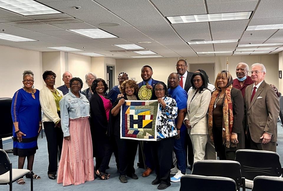 Gee's Bend quilters and representatives from the Freedom Quilting Bee Legacy smile alongside State Sen. Robert Stewart in the Alabama State House.