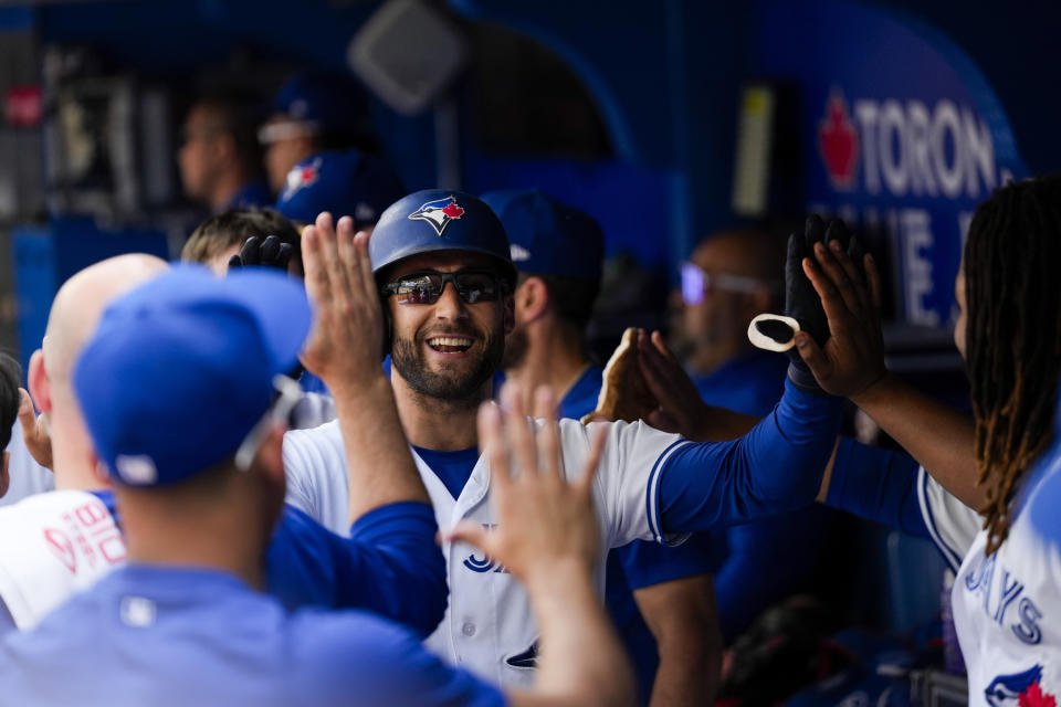 Toronto Blue Jays' Cavan Biggio (8) celebrates after scoring a run on a sacrifice fly by teammate Kevin Kiermaier, not pictured, during the second inning of a baseball game against the Boston Red Sox in Toronto, Sunday, Sept. 17, 2023. (Andrew Lahodynskyj/The Canadian Press via AP)