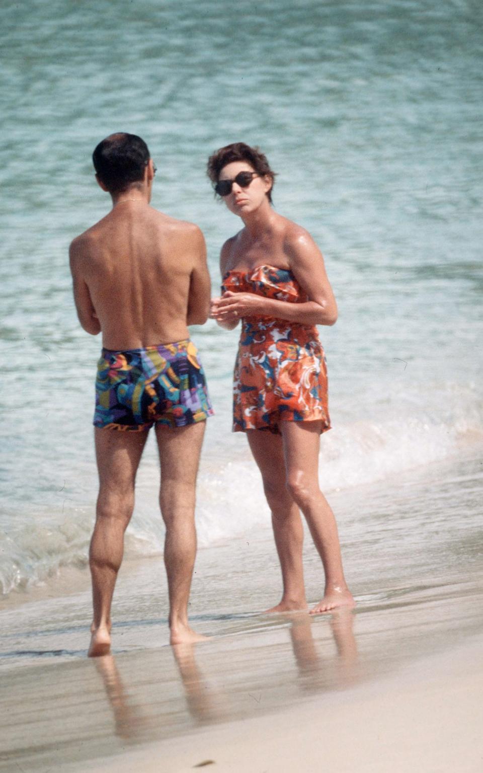 Margaret chats to a friend on the beach whilst on holiday on February 01, 1976 in Mustique, West Indies - Getty