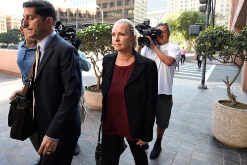 FILE - In this Thursday, Aug. 23, 2018 file photo, Margaret Hunter, center, the wife of U.S. Rep. Duncan Hunter, arrives for an arraignment hearing in San Diego. Rep. Duncan Hunter's wife is planning to change her not-guilty plea after the couple was charged with using more than $250,000 in campaign funds on vacations and other expenses. Margaret Hunter, who worked as the California Republican's campaign manager, is scheduled to appear in federal court Thursday, June 12, 2019 to change her plea.(AP Photo/Denis Poroy) ORG XMIT: FX102