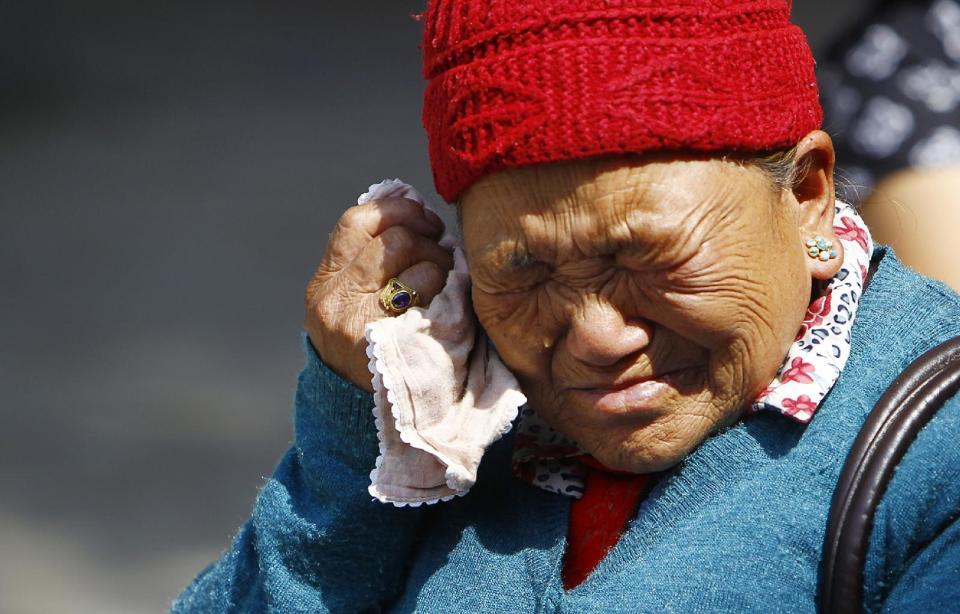 Mother of Nepalese mountaineer Ang Kaji Sherpa, killed in an avalanche on Mount Everest, cries while she waits for his body at Sherpa Monastery in Katmandu, Nepal, Saturday, April 19, 2014. Rescuers were searching through piles of snow and ice on the slopes of Mount Everest on Saturday for four Sherpa guides who were buried by an avalanche that killed 12 other Nepalese guides in the deadliest disaster on the world's highest peak. The Sherpa people are one of the main ethnic groups in Nepal's alpine region, and many make their living as climbing guides on Everest and other Himalayan peaks. (AP Photo/Niranjan Shrestha)