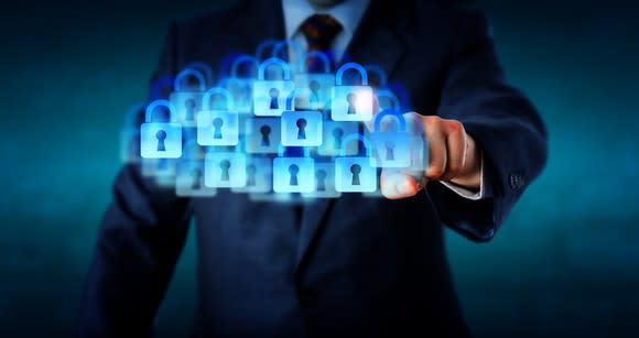 A businessman presses a "cloud" of digital padlocks.