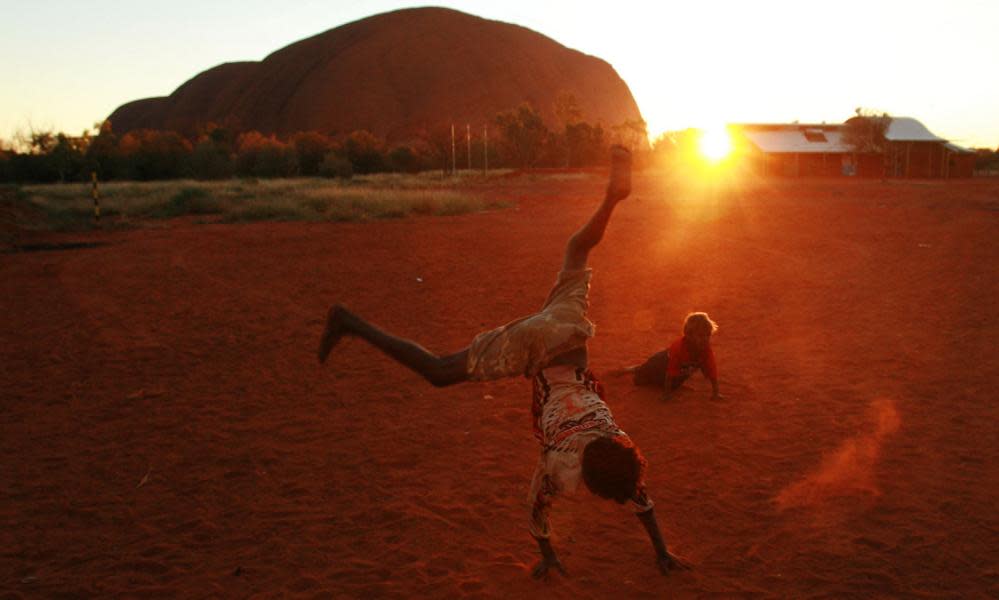 Children play near Uluru